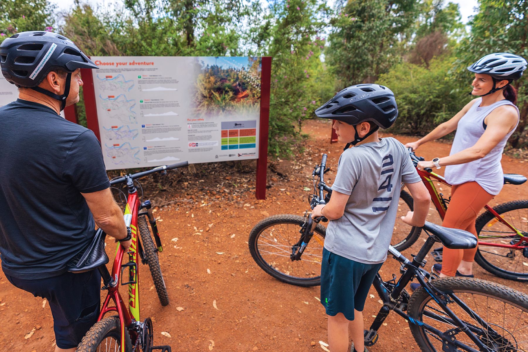 Cyclists studying trailhead map before Munda Biddi bike tour departure