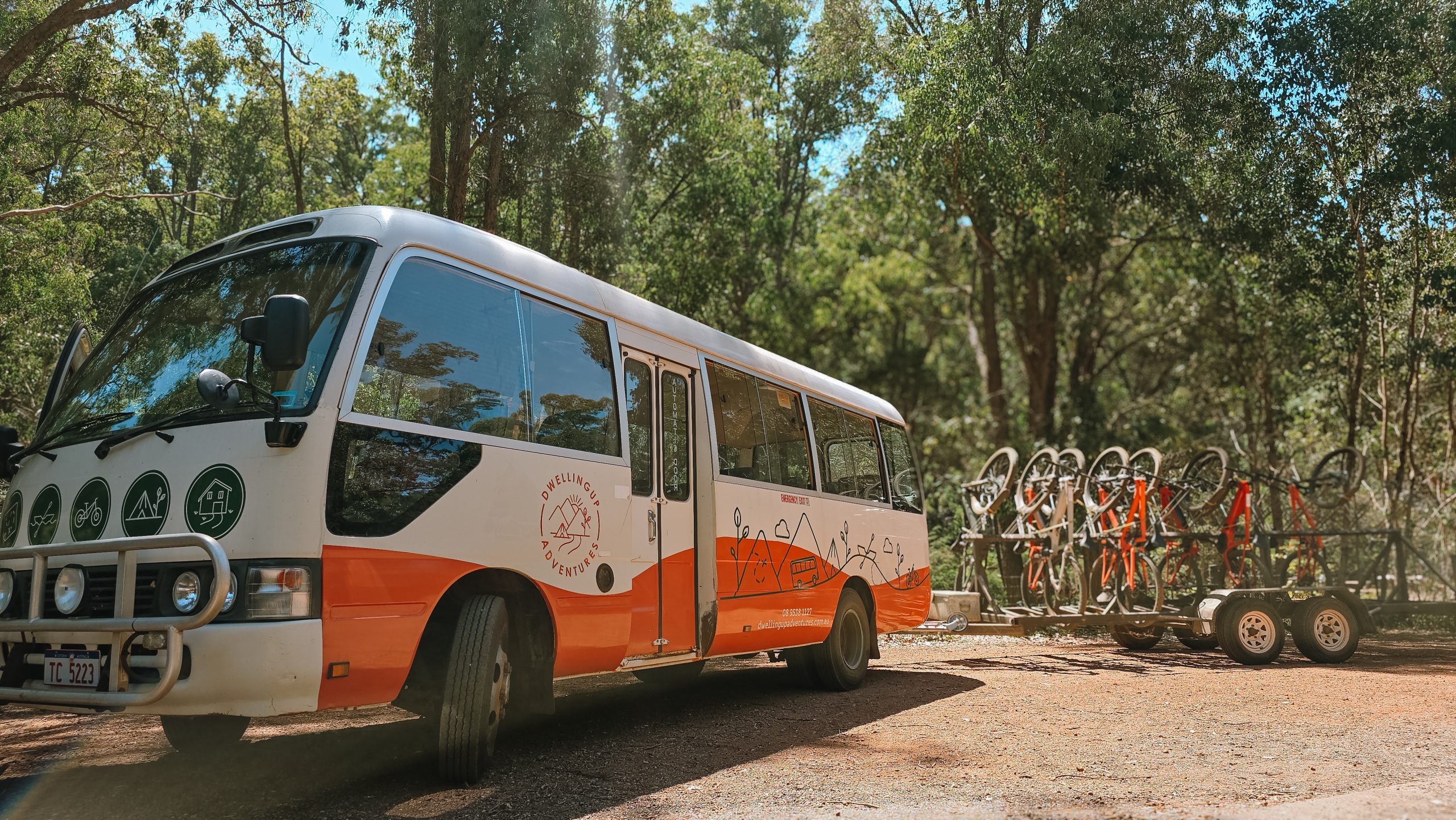 Charter bus with mountain bike rack at forest pickup point